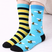 Load image into Gallery viewer, Two pairs of socks with bee patterns and black and yellow stripes on a white background.