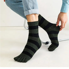 Load image into Gallery viewer, Person wearing black and gray striped toe socks on a light background