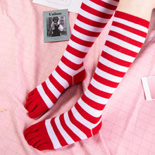 Load image into Gallery viewer, Red and white striped socks on a pink checkered background