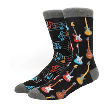 Load image into Gallery viewer, Two black socks with guitar and music note designs on a white background