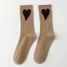 Load image into Gallery viewer, Pair of beige socks with black heart designs on a white background