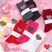 Load image into Gallery viewer, Colorful socks with heart-shaped embellishments on a pink background
