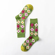 Load image into Gallery viewer, Green socks with floral patterns on a white background
