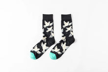 Load image into Gallery viewer, Black socks with white dog patterns on a white background