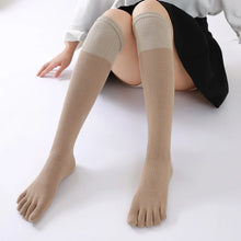 Load image into Gallery viewer, A pair of tan knee-high socks with distinct toe separation, designed for comfort and reducing toe friction.