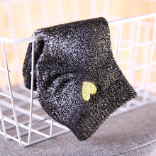 Load image into Gallery viewer, Black glittery tie with a gold heart on a white chair