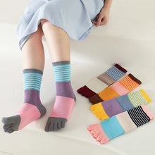 Load image into Gallery viewer, Colorful toe-separated socks with a person wearing them on a light background