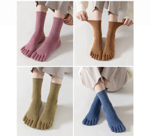 Load image into Gallery viewer, A collection of toe socks in various muted colors, displayed in pairs with the toes facing upwards to show the fit and color. The socks appear to be made with a cotton-rich/spandex mix.