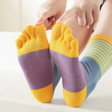 Load image into Gallery viewer, Colorful toe-separated socks being worn on a light background