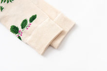 Load image into Gallery viewer, Beige fabric with green leaf embroidery on a white background