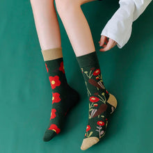 Charger l'image dans la galerie, Person wearing floral-patterned socks on a green background
