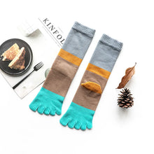 Load image into Gallery viewer, Colorful toe socks with a casual setting including a plate of toast and a pine cone.
