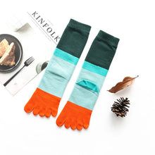 Load image into Gallery viewer, Colorful toe socks with green, blue, and orange sections on a white surface.
