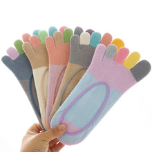 Load image into Gallery viewer, Set of colorful toe socks held by a hand on a white background
