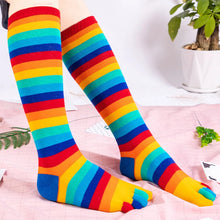 Load image into Gallery viewer, Colorful rainbow striped knee-high socks on a light background
