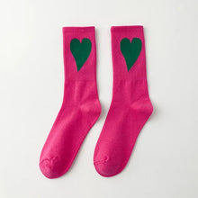Load image into Gallery viewer, Pair of pink socks with green hearts on a white background
