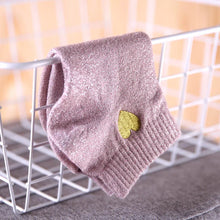 Load image into Gallery viewer, Pink glittery dog sweater with a green heart patch on a wire rack.
