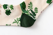 Load image into Gallery viewer, Close-up of a green leaf-patterned sock on a white background
