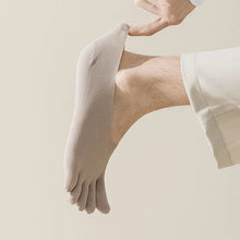 Load image into Gallery viewer, Person wearing beige toe-separated socks on a plain background

