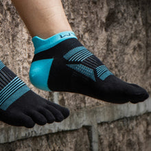 Load image into Gallery viewer, Black and blue toe-separated socks with text 'Get Rid of Toe Restraint' on a stone background.
