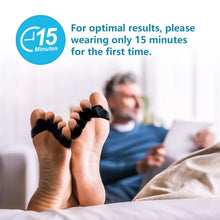 Load image into Gallery viewer, Person wearing toe separators with a blurred background of a person using a tablet.
