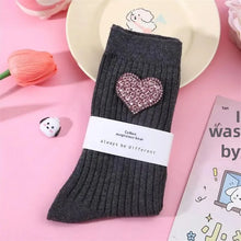 Load image into Gallery viewer, Dark gray sock with a pink heart design on a pink background
